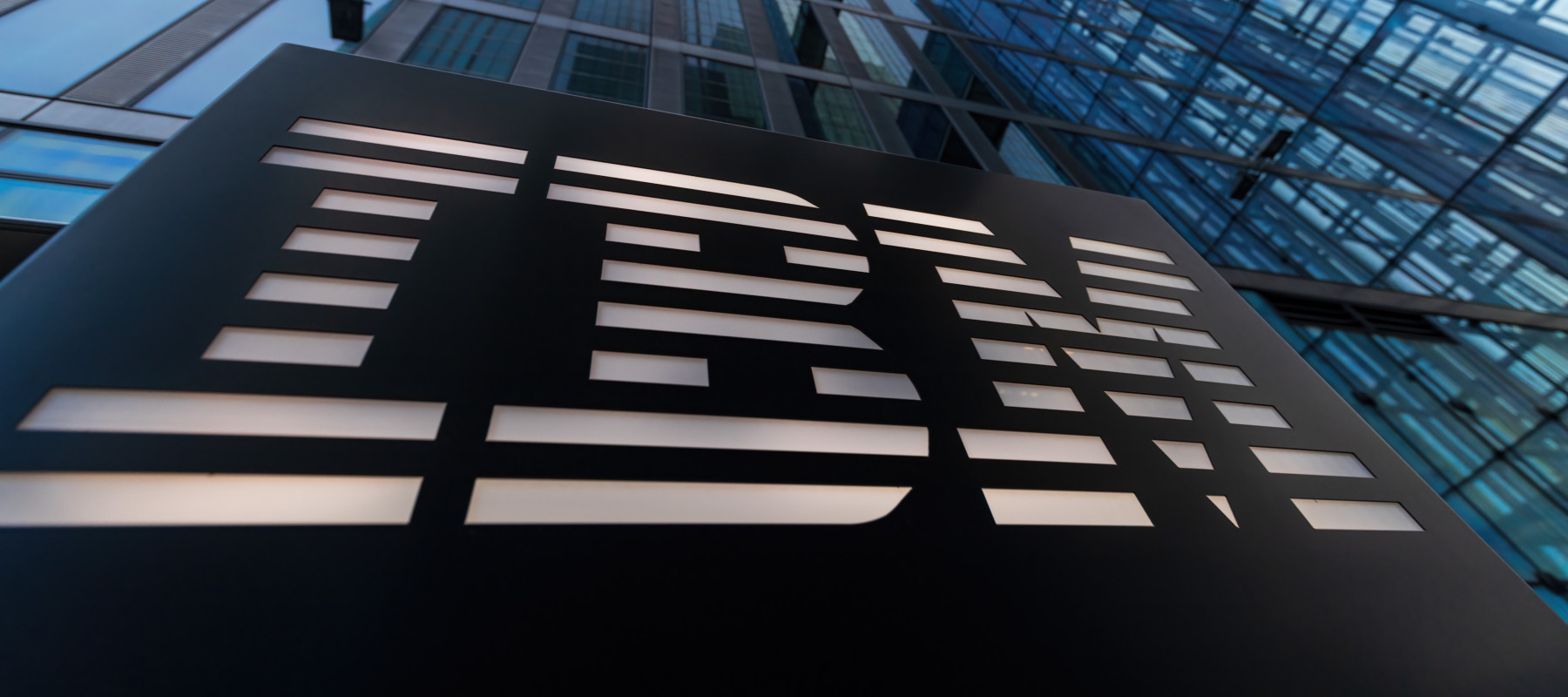 A close up of the exterior of an IBM office building logo in a city setting.