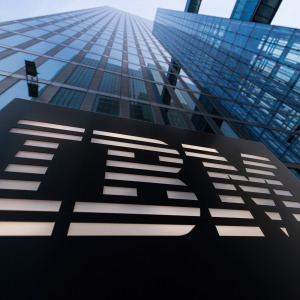 A close up of the exterior of an IBM office building logo in a city setting.
