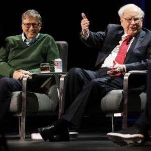 Bill Gates and Warren Buffett on stage together at a speaking event.