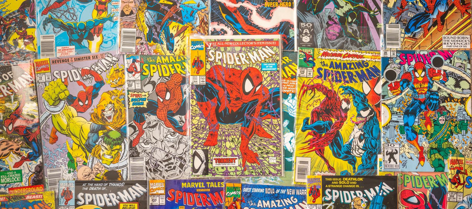 Tons of Spider-Man comics spread out on a table