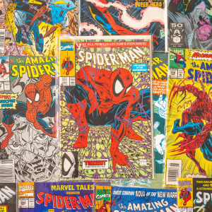 Tons of Spider-Man comics spread out on a table
