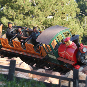 People ride Big Thunder Mountain roller coaster at Disneyland.
