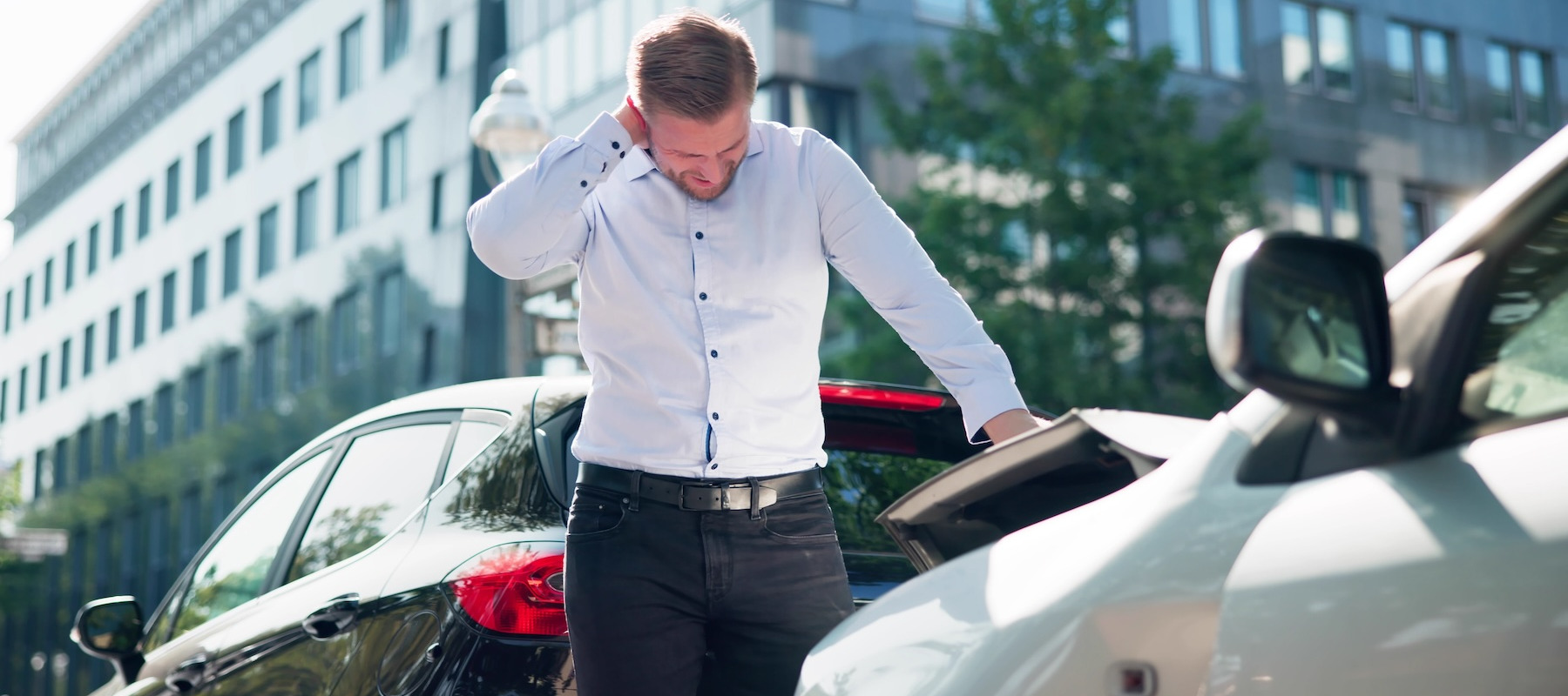 Man suffering from neck pain after a car accident.