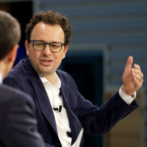 Andrew Ross Sorkin and Dario Amodei speak onstage. Amodei is gesturing.