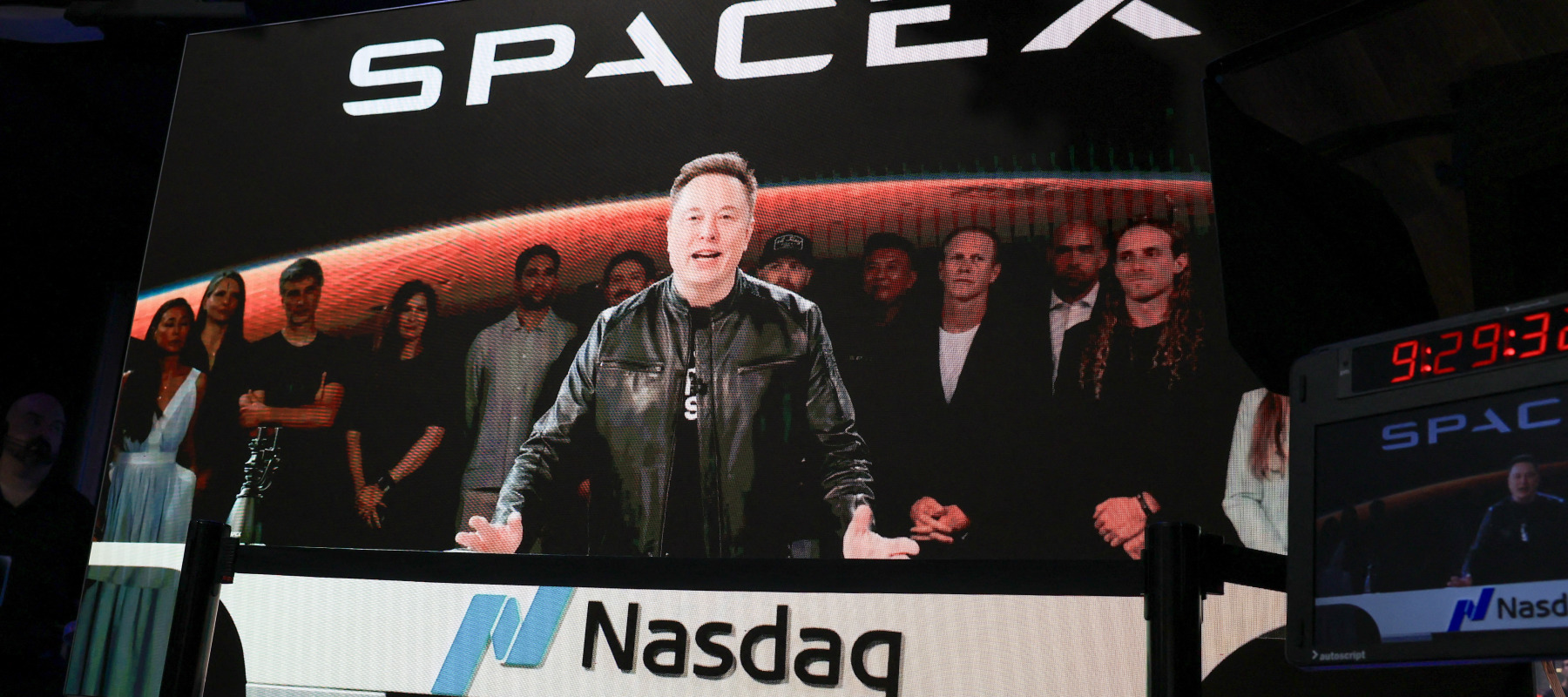 SpaceX CEO Elon Musk, displayed on a screen remotely from SpaceX headquarters in Starbase, Texas, speaks before the launch of SpaceX's initial public offering .