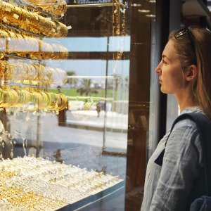 Woman browsing gold jewels in window