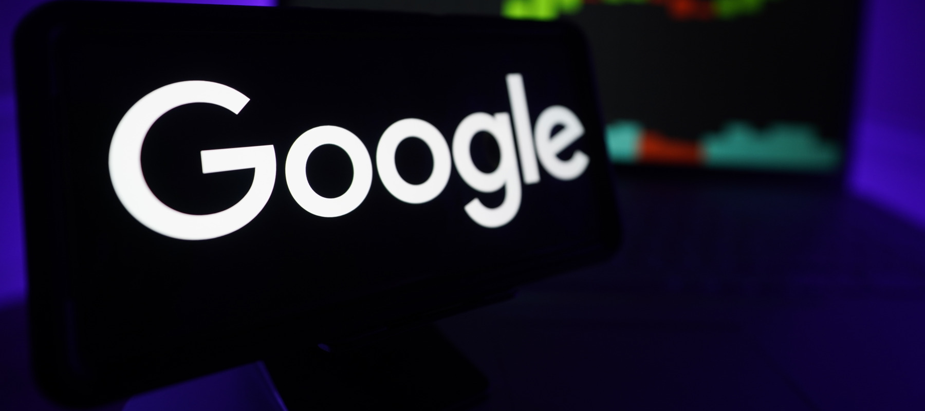Google logo displayed on a screen with real-time market analytics.