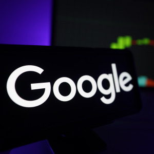 Google logo displayed on a screen with real-time market analytics.