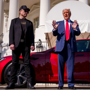 U.S. President Donald Trump, accompanied by Tesla and SpaceX CEO Elon Musk, speaks next to a Tesla Model S on the South Lawn of the White House.