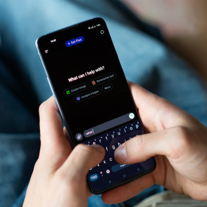A photo of a man using ChatGPT on his phone