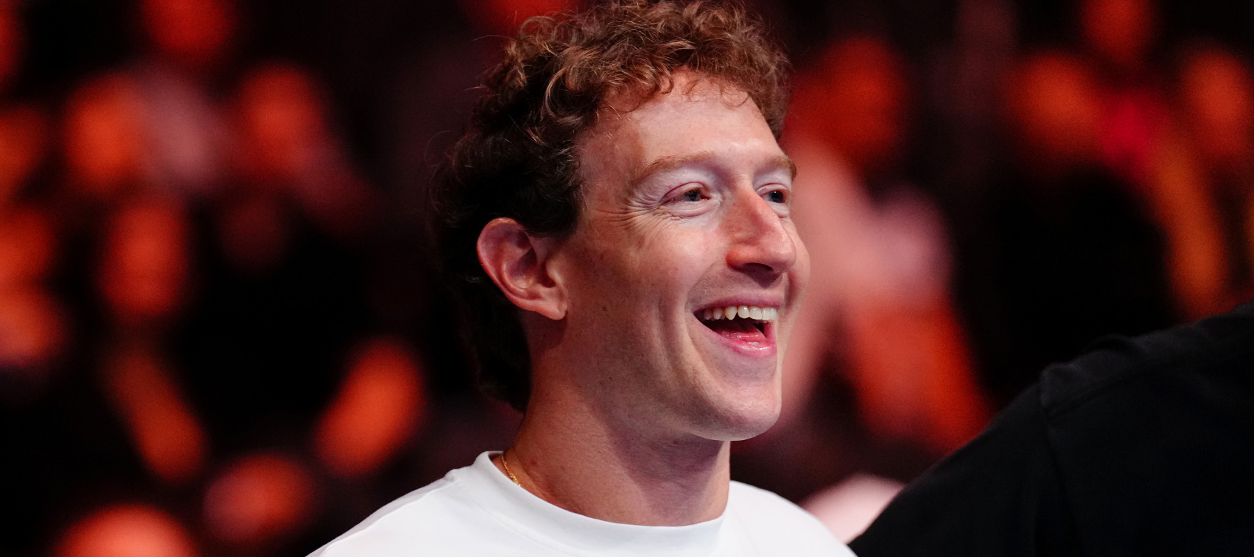 Mark Zuckerberg smiles widely while attending the UFC 320 event.