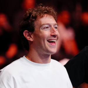 Mark Zuckerberg smiles widely while attending the UFC 320 event.