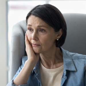 Upset woman sitting on a couch.