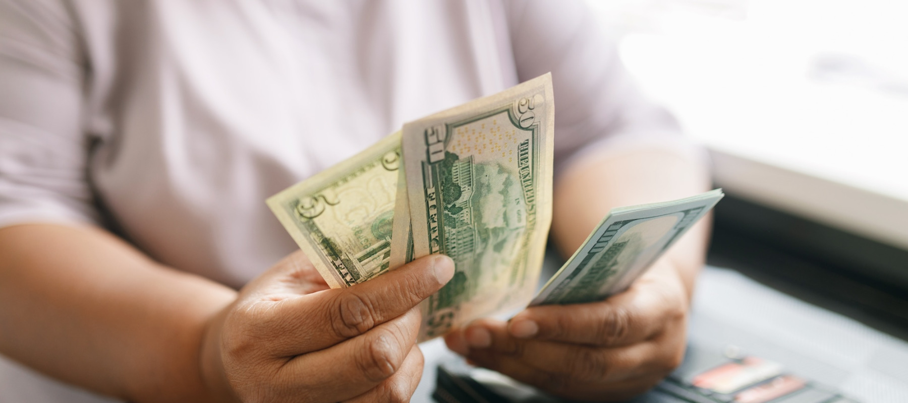 A photo of a woman counting cash