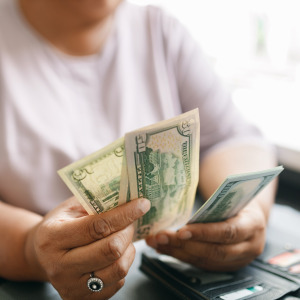 A photo of a woman counting cash