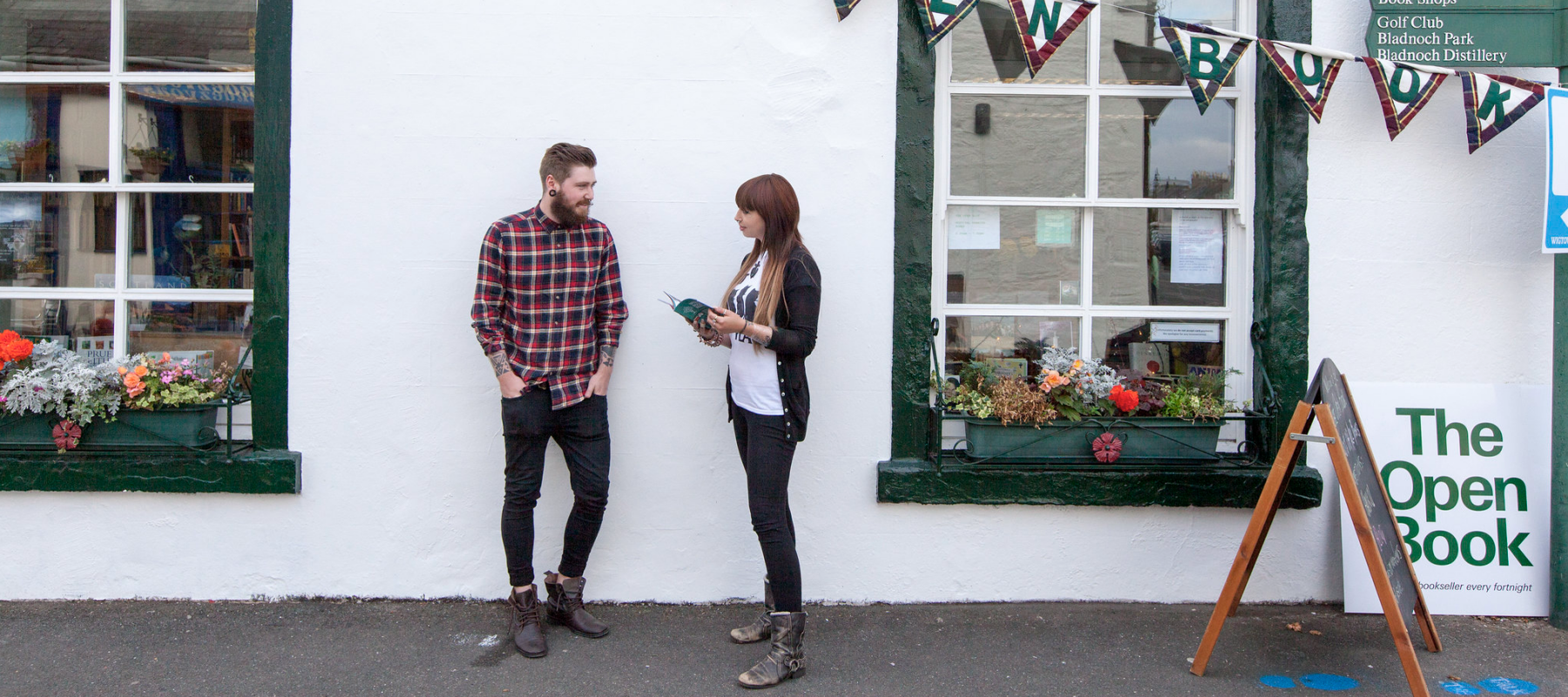 A couple standing outside of The Open Book in Scotland