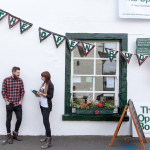 A couple standing outside of The Open Book in Scotland