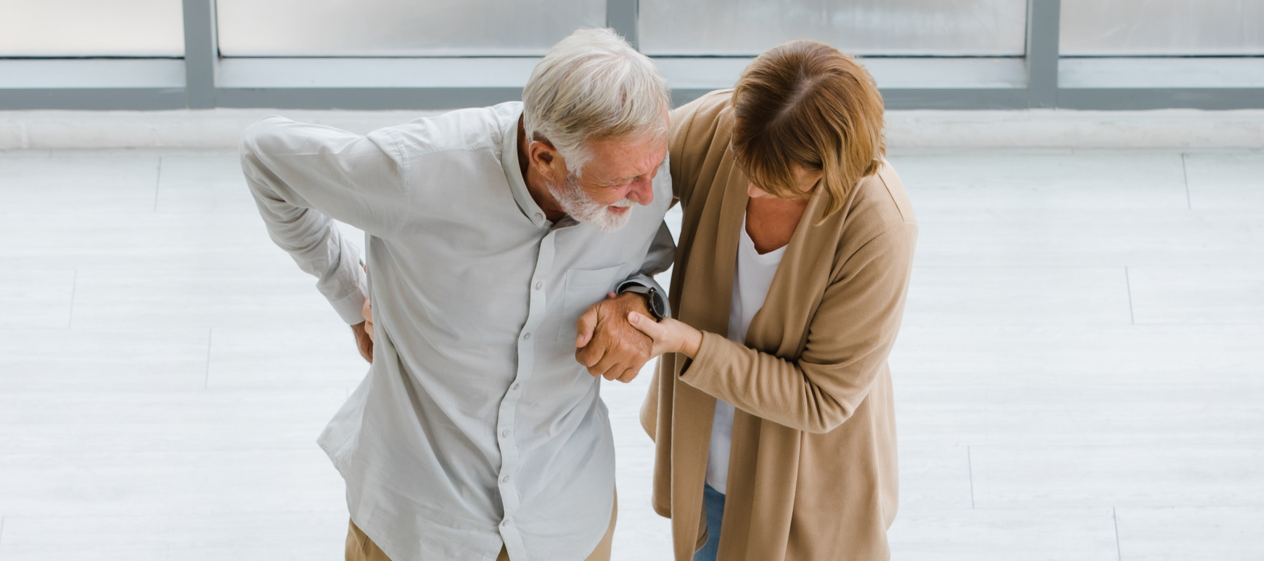 Wife helps elderly husband recovering from a stroke.