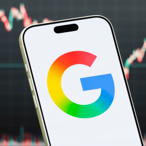 A photo of the Google logo in front of a stock chart