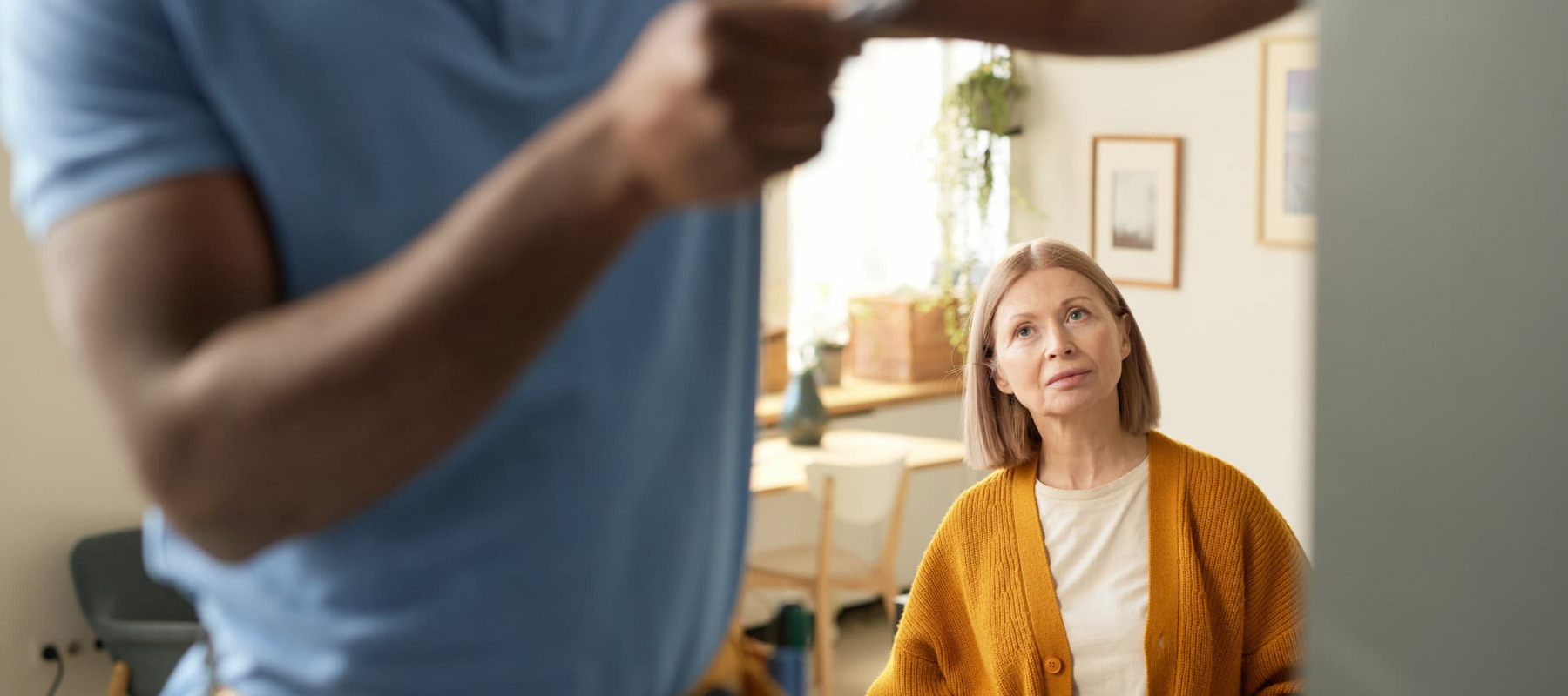 A photo of a woman talking to a handyman