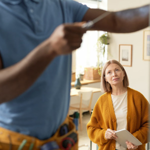 A photo of a woman talking to a handyman