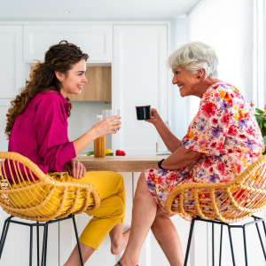 A photo of a woman drinking coffee with her grandmother