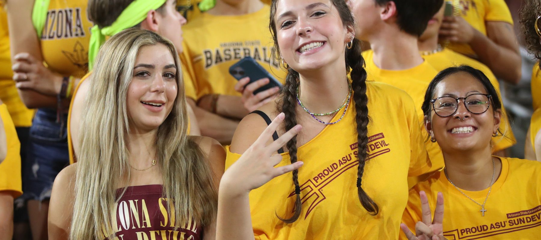 Arizona State students pose for a picture at a home basketball game.
