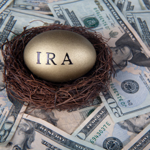 Money and nest eggs concept for retirement with $20 U.S. bank notes on a table.