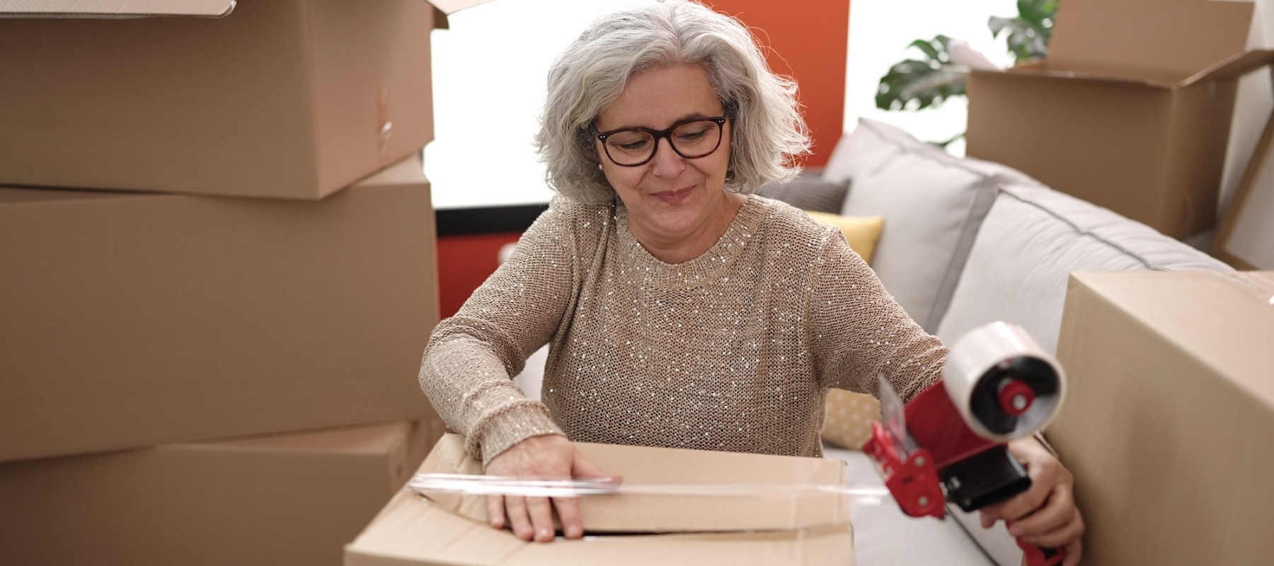A photo of a woman packing up boxes