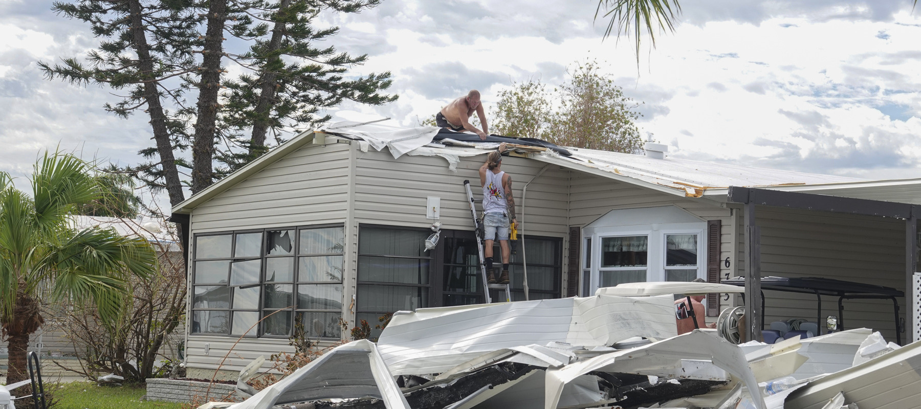 Workers fix a Floridian home damaged in the wake of Hurricane Ian in 2022.