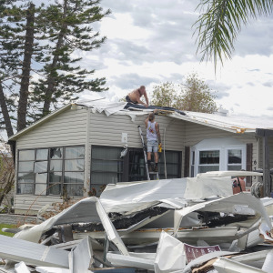 Workers fix a Floridian home damaged in the wake of Hurricane Ian in 2022.
