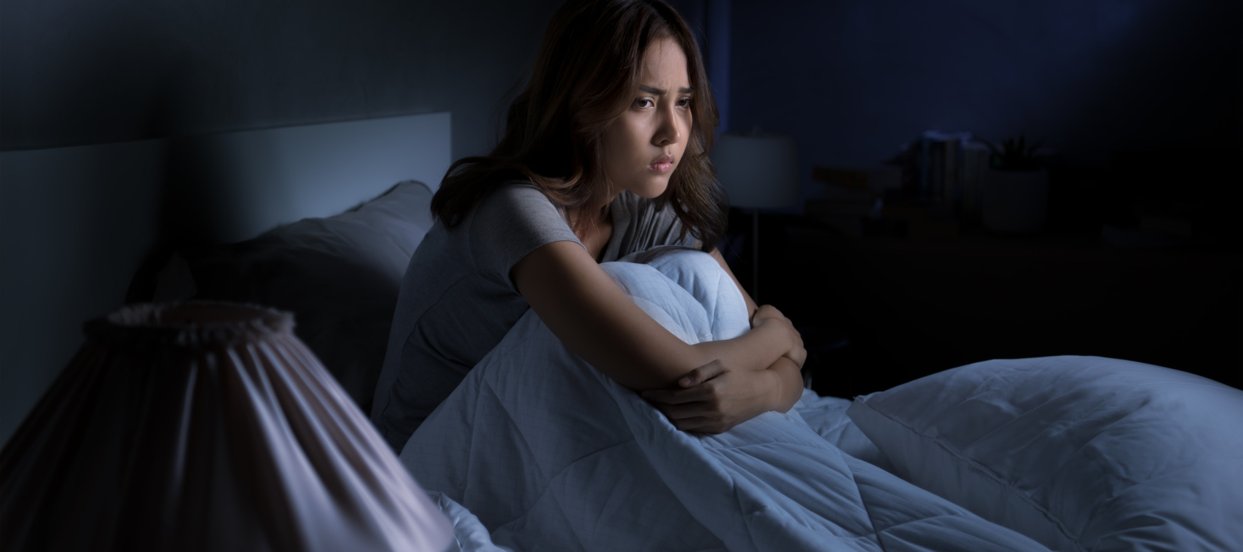 woman sitting up in bed