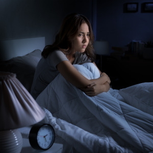 woman sitting up in bed