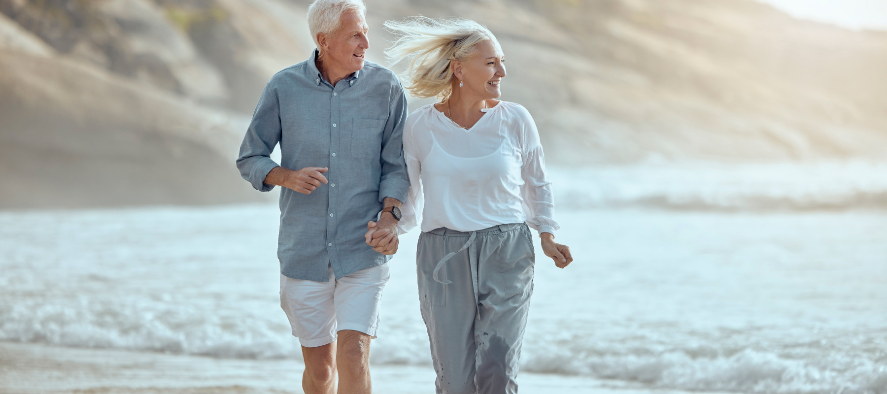 A retired couple enjoying their time on the beach.