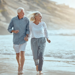 A retired couple enjoying their time on the beach.
