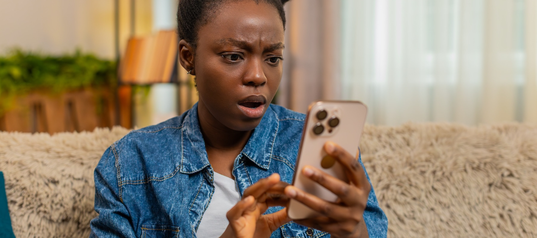 Shocked woman looking at her phone.