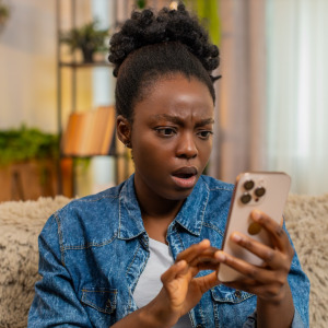 Shocked woman looking at her phone.