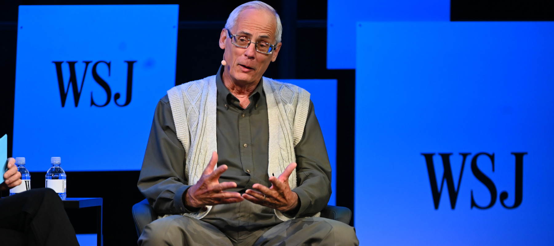 Ted Benna speaking on stage.