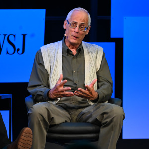 Ted Benna speaking on stage.