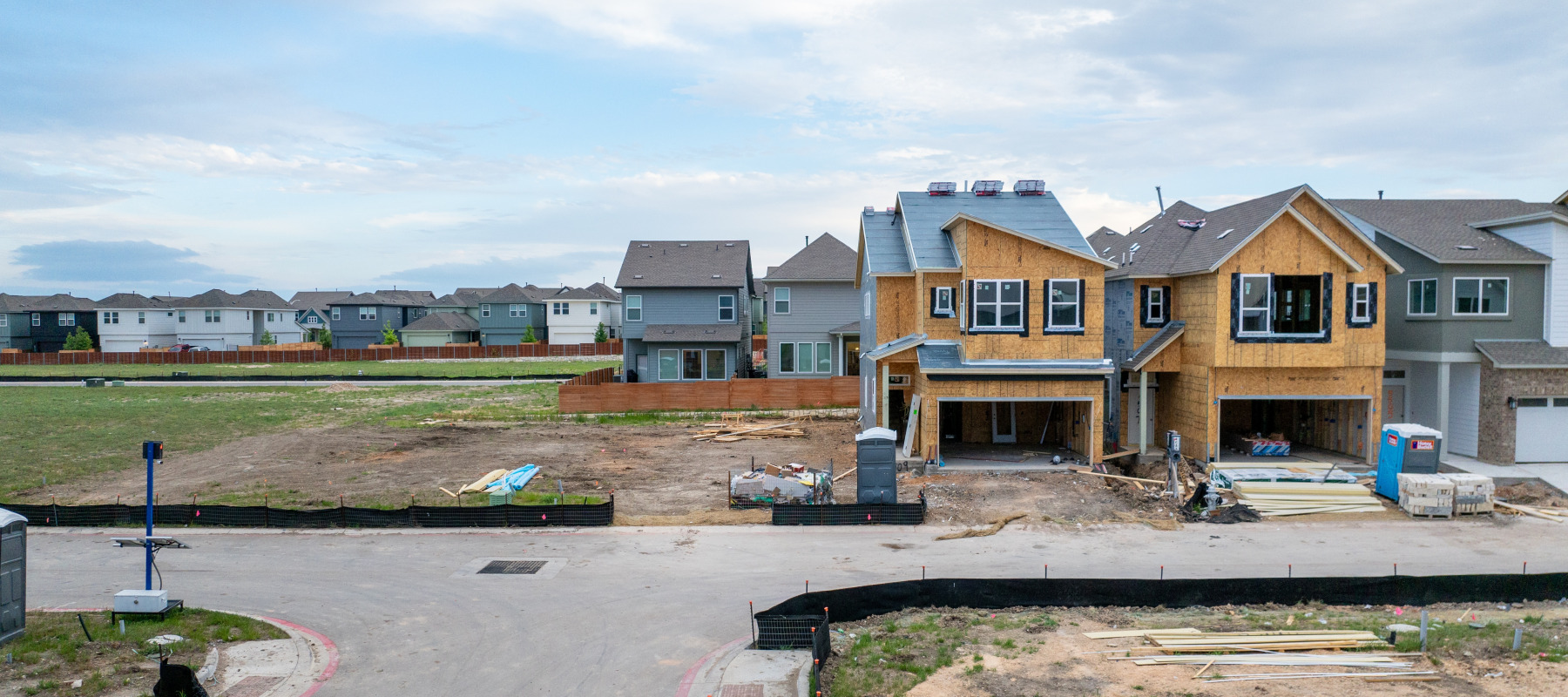 An aerial view of houses undergoing construction in a Texas neighborhood.
