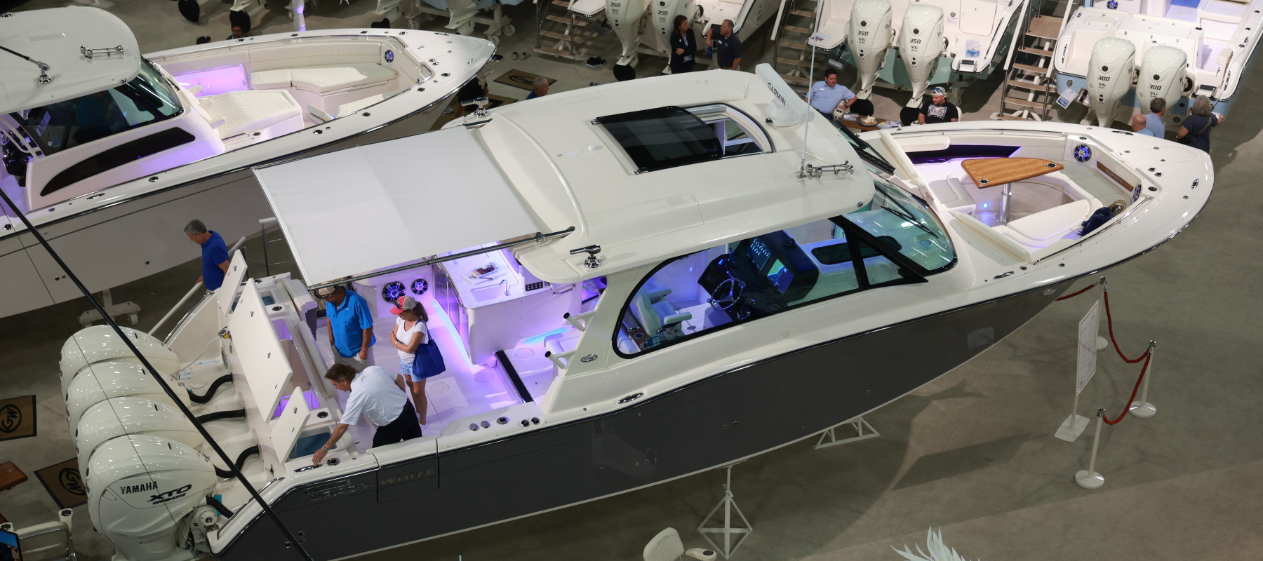 People visit Grady-White boats on display at the 2024 Discover Boating Miami International Boat Show.