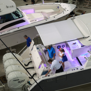 People visit Grady-White boats on display at the 2024 Discover Boating Miami International Boat Show.