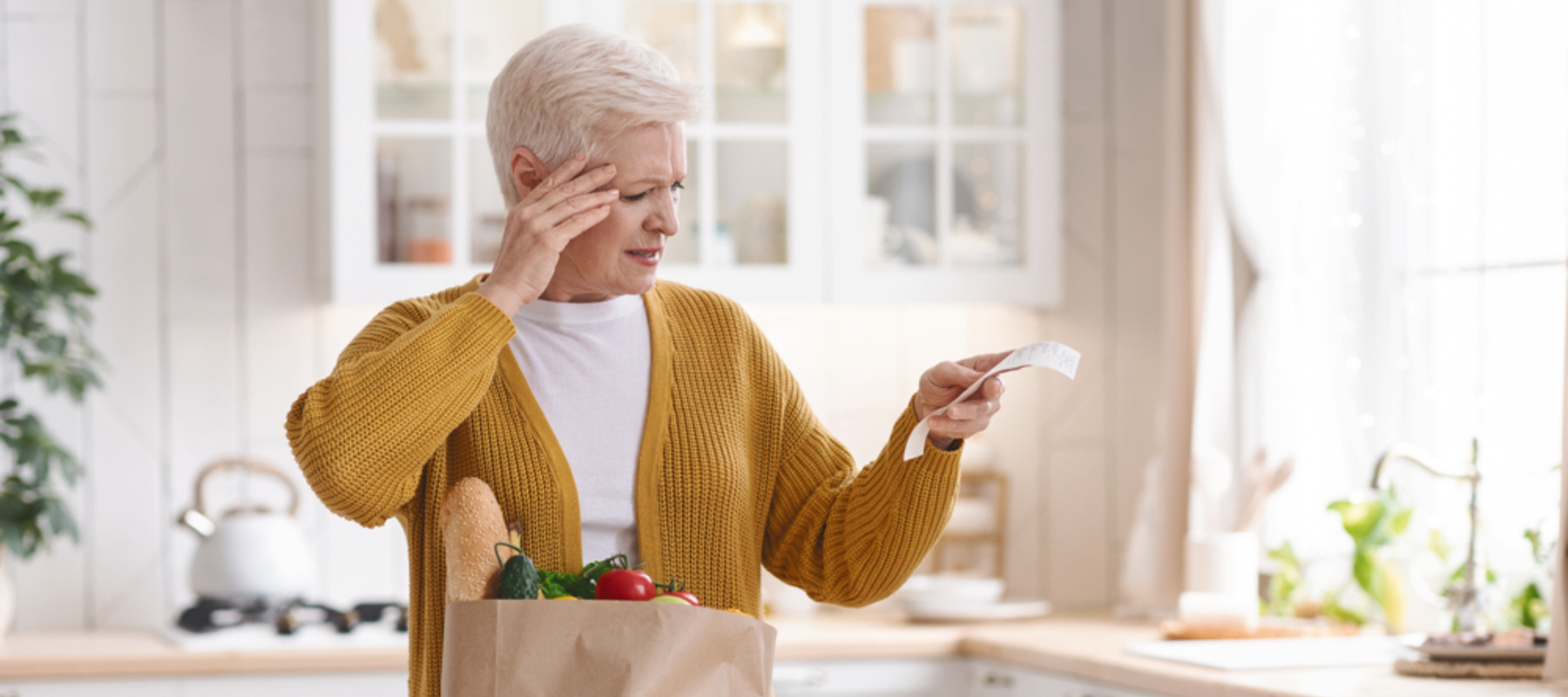Photo of an older woman looking at her grocery bill