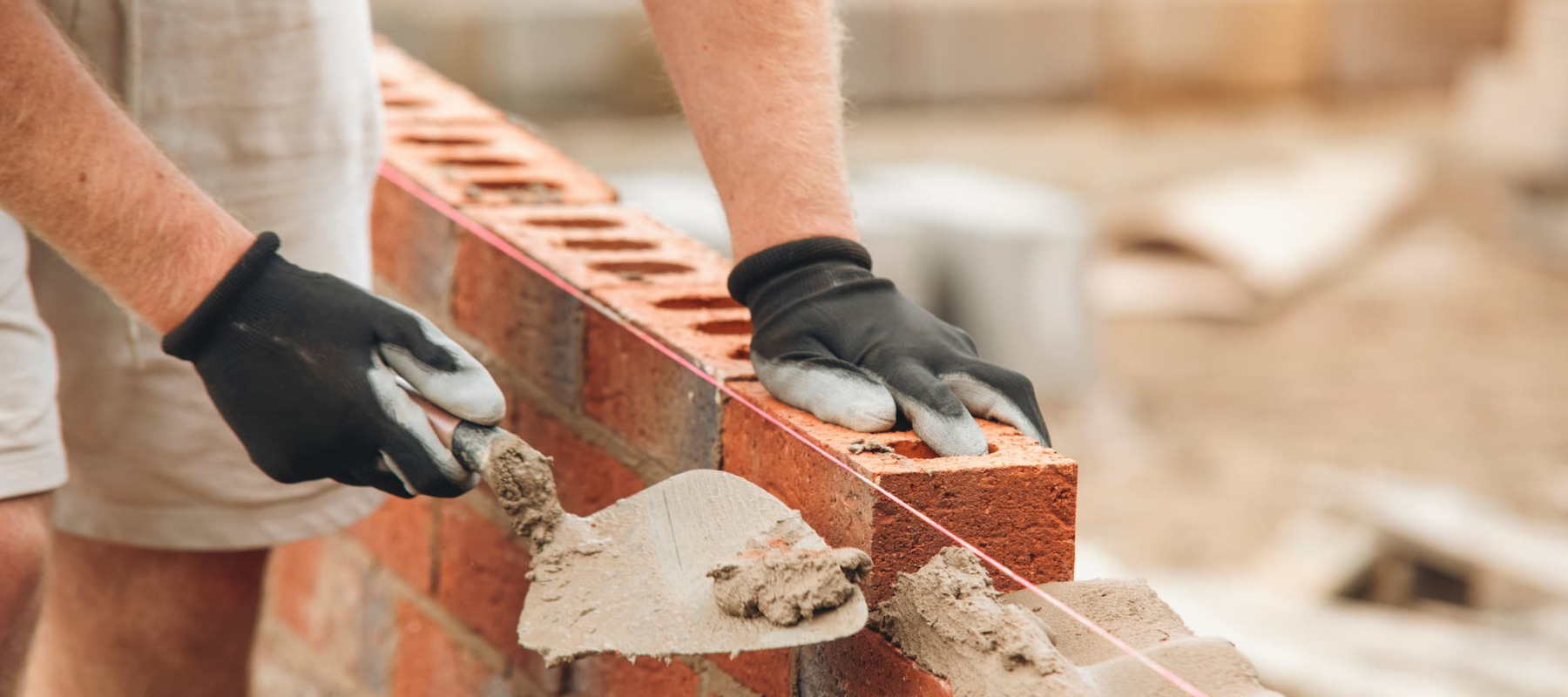 A photo of a man laying down brick