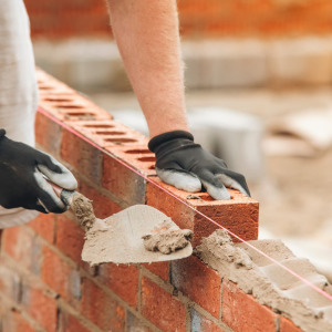 A photo of a man laying down brick