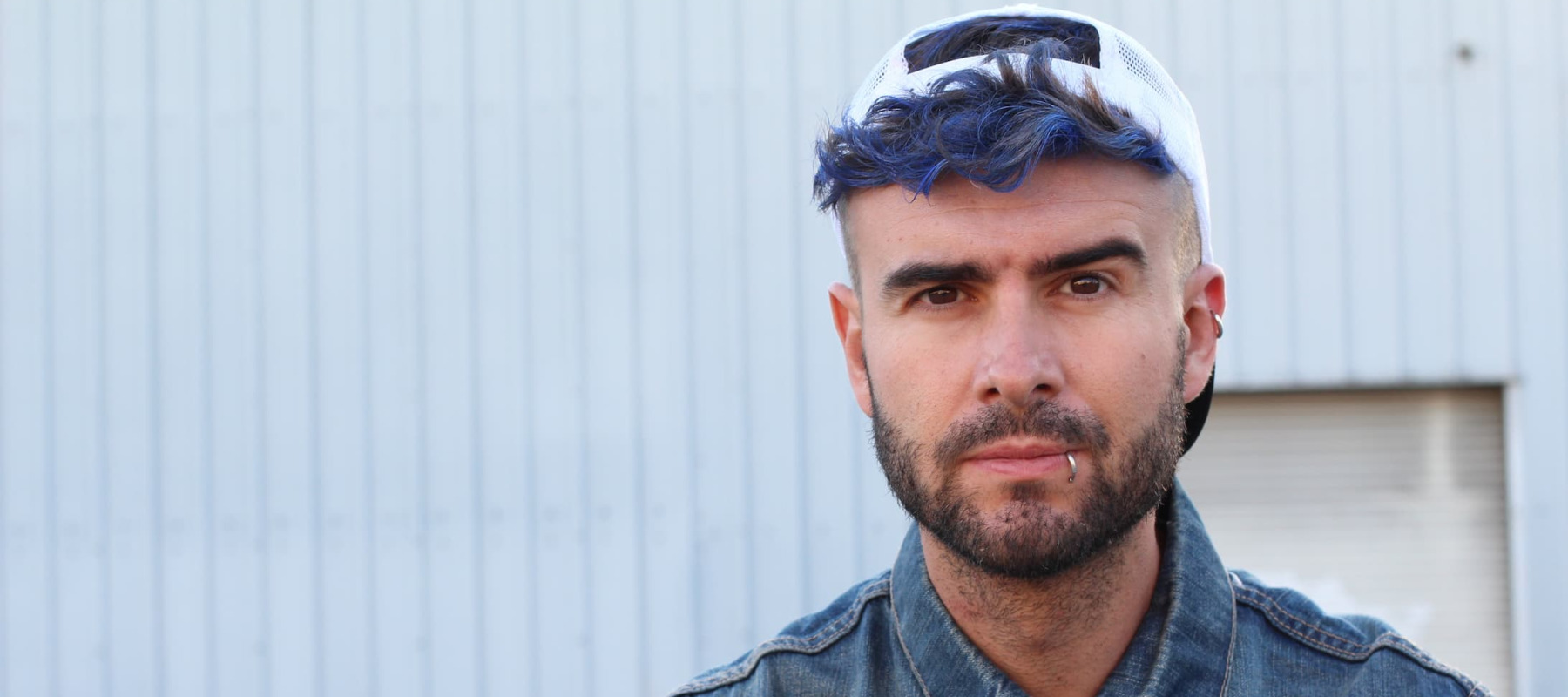 A photo of a man with blue hair