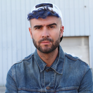A photo of a man with blue hair
