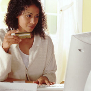 Woman shopping online with her credit card.