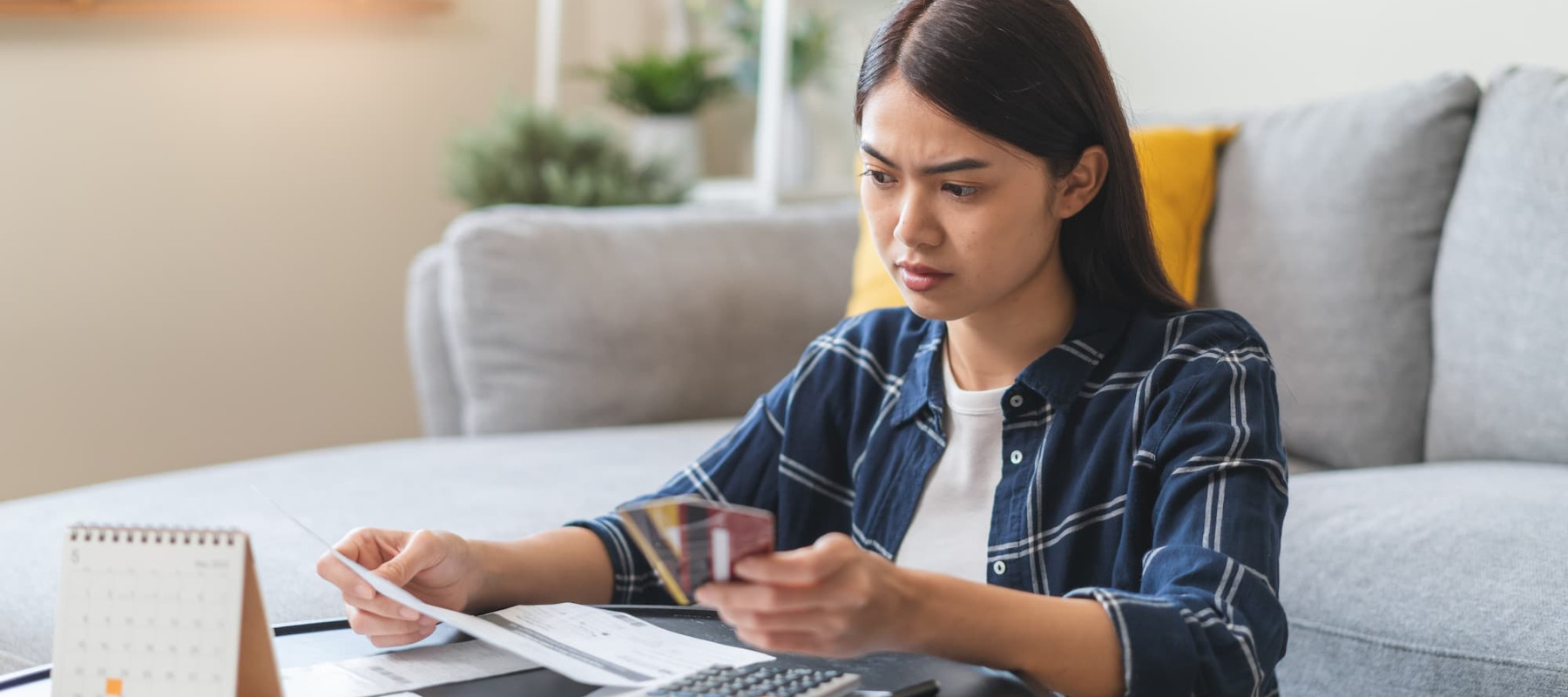 A photo of a woman reviewing her credit card debt