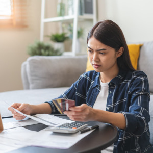 A photo of a woman reviewing her credit card debt